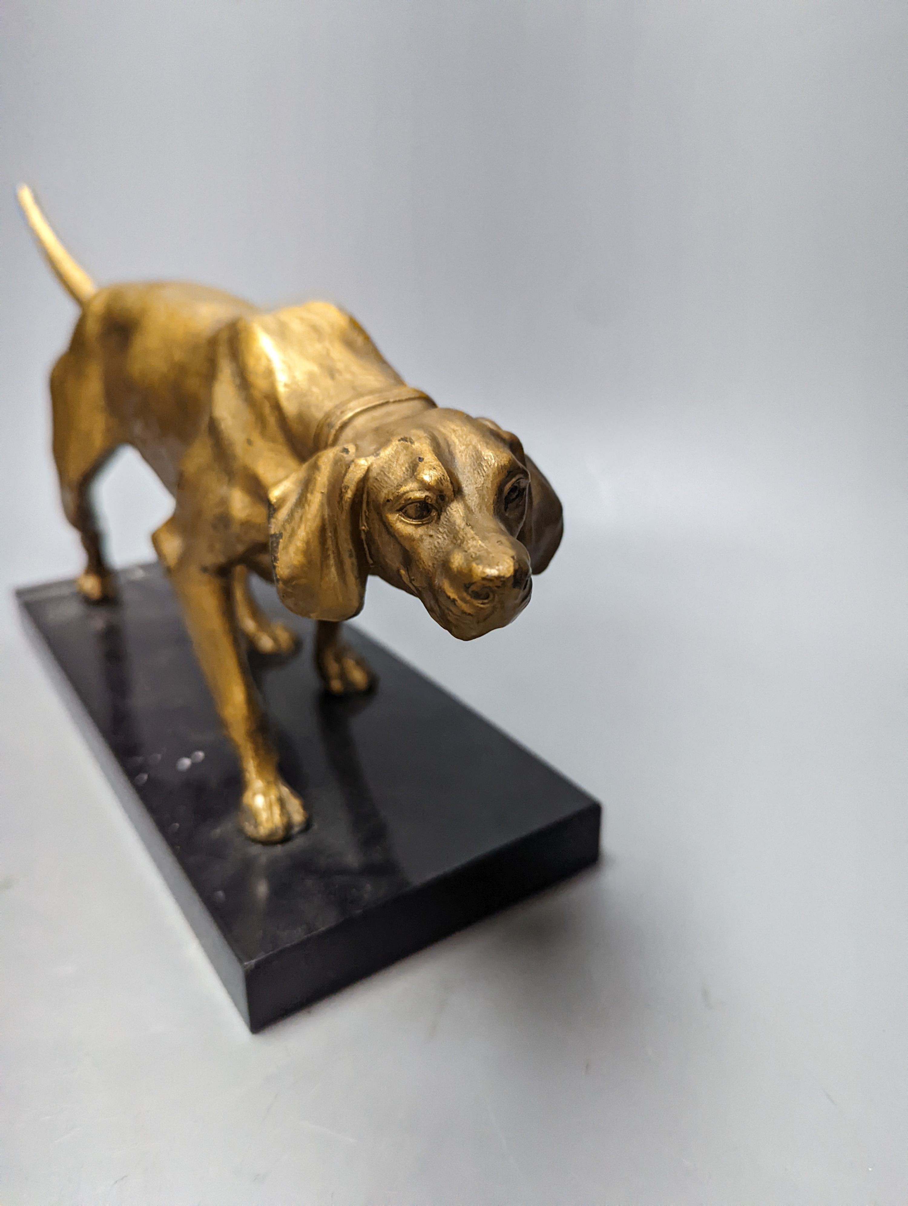 A gilt-metal model of a pointer on marble base 29cm